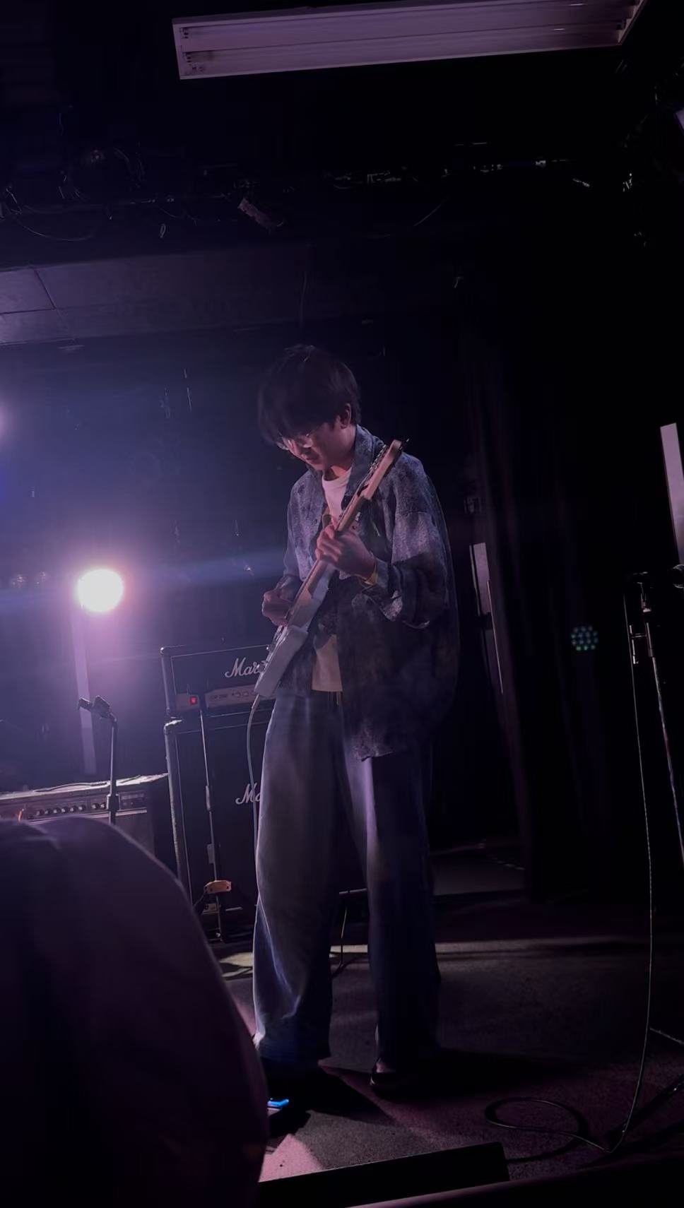 Zhaoyang Yuan playing electric guitar on stage at Umeda Zeela